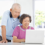 older couple looking at easy long-term care insurance on a computer